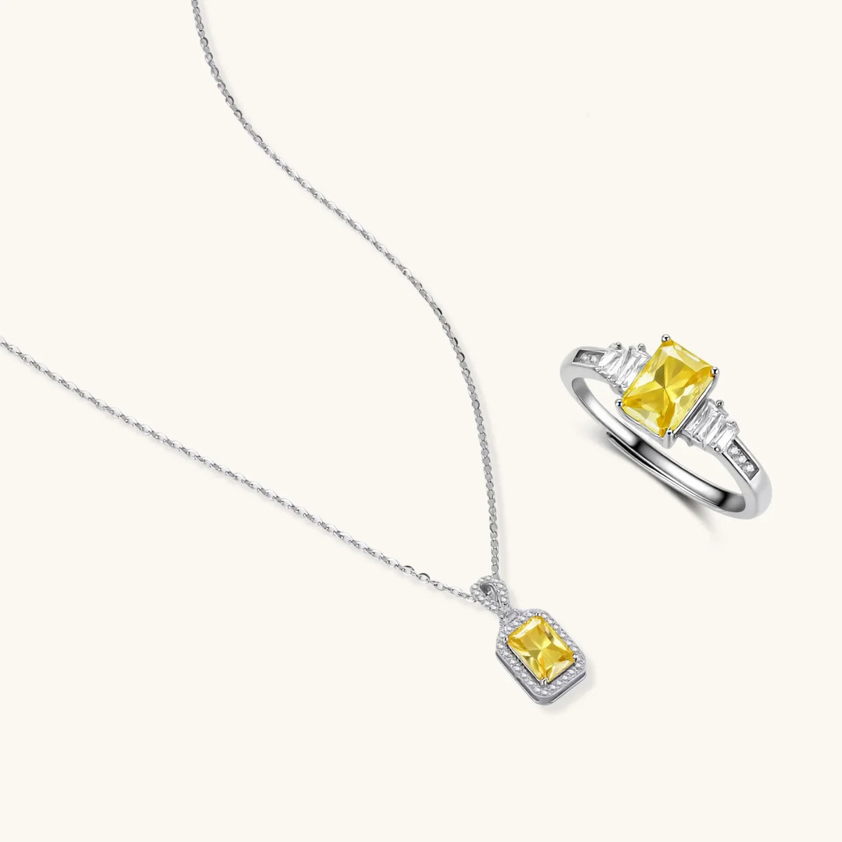 Yellow moissanite jewellery set with emerald-cut stones in sterling silver halo settings.