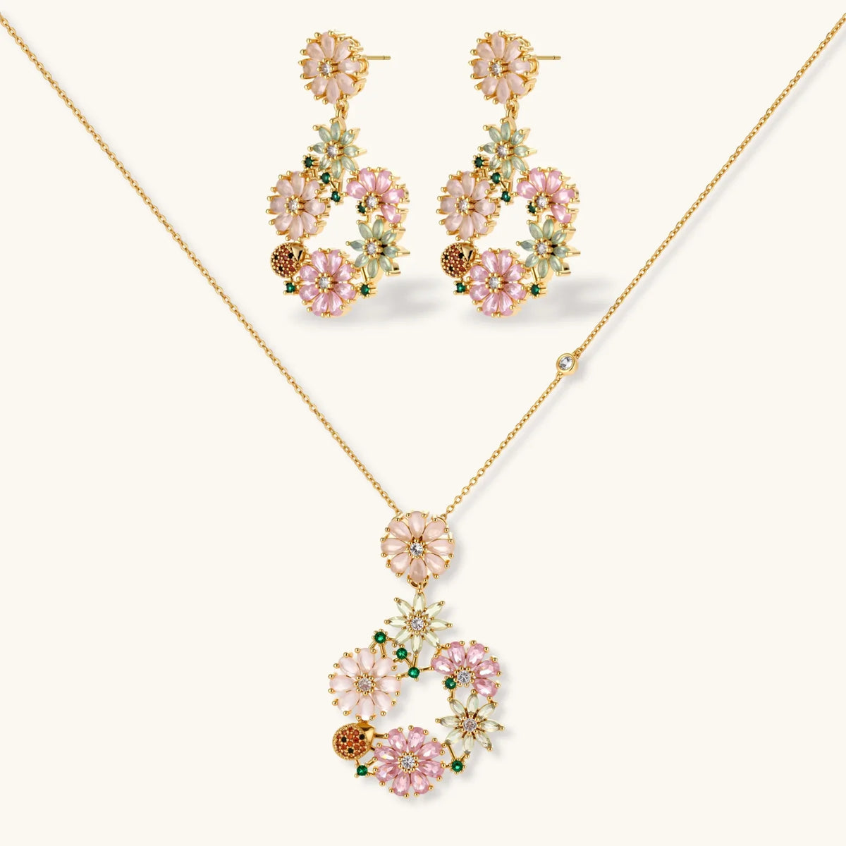 14K gold-plated jewellery set with pink and green cubic zirconia flowers arranged in a wreath design.