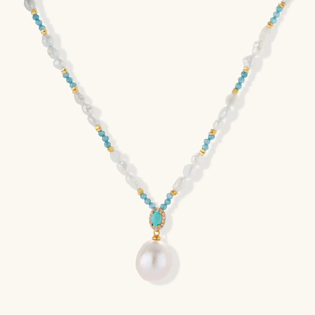 Beaded necklace with baroque pearls, turquoise stones and gold accents featuring a large pearl pendant.