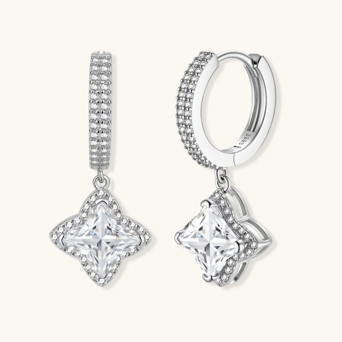 Sterling silver huggie hoops with geometric moissanite dangles and pavé crystal details.