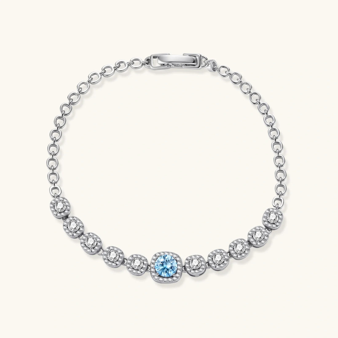 Sterling silver tennis bracelet with round halo-set moissanite stones and a blue centre stone.