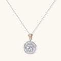 Sterling silver necklace with circular geometric pendant featuring central moissanite and radial baguette pattern.