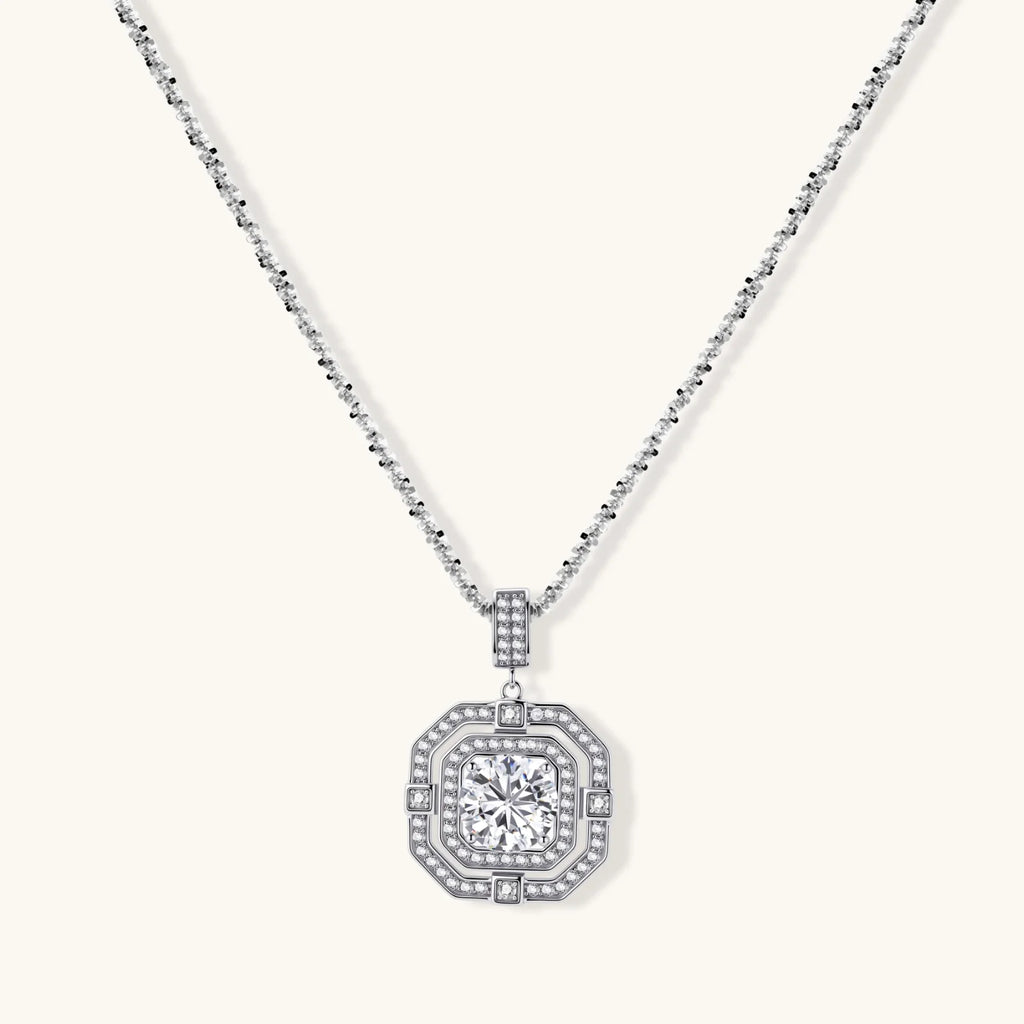 Sterling silver octagonal pendant necklace with brilliant moissanite center stone and halo setting on white background.