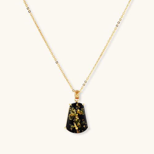 18k gold-plated necklace and earrings with green amber pendants featuring golden inclusions on cream background