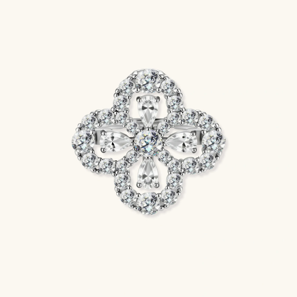Adjustable sterling silver ring with quatrefoil design featuring brilliant moissanite stones in clover pattern
