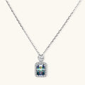 Sterling silver necklace with rectangular rainbow moissanite pendant and teardrop accent stone on white background