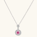 Sterling silver pendant necklace with pink moissanite center stone and clear crystal halo setting on neutral background.