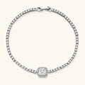 Sterling silver tennis bracelet with cushion-cut moissanite centerpiece surrounded by smaller stones in continuous setting